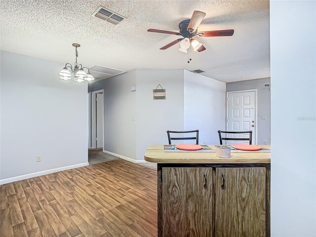 4531 Blossom Blvd Unit 4531, Zephyrhills, FL 33542 - kitchen featuring hardwood / wood-style floors, ceiling fan with notable chandelier, and a textured ceiling