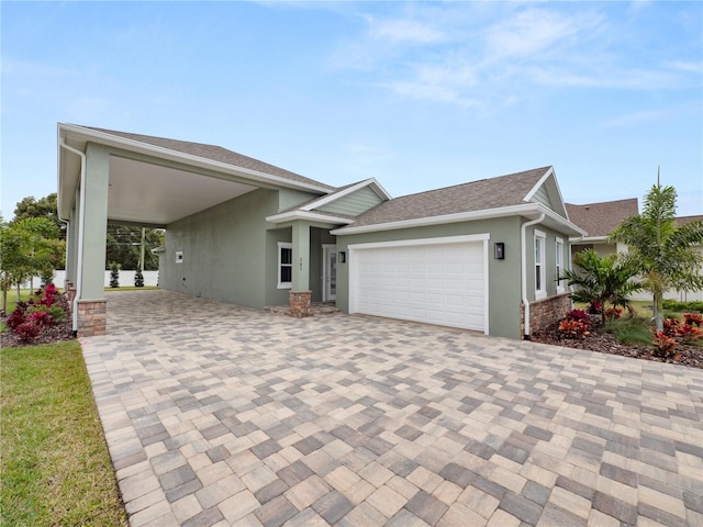 view of front of home with a garage and a carport