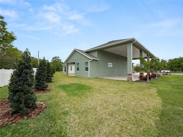 back of property with a yard and a patio