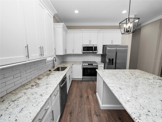 kitchen featuring tasteful backsplash, light stone counters, decorative light fixtures, white cabinets, and appliances with stainless steel finishes