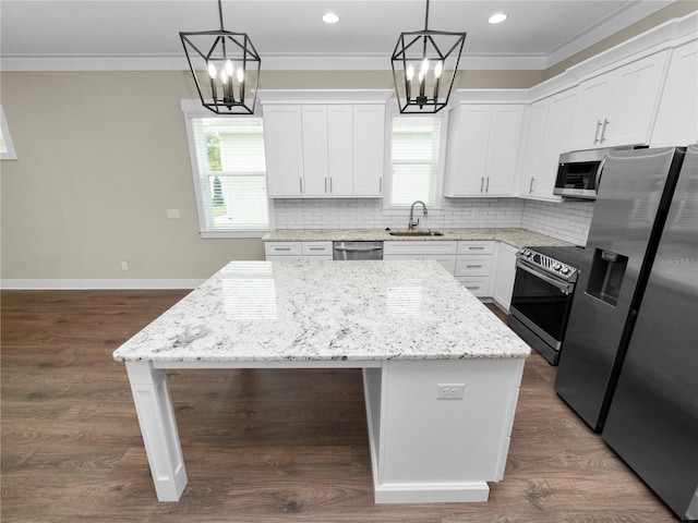 kitchen featuring white cabinets, a kitchen island, and appliances with stainless steel finishes