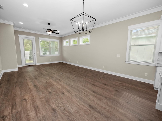 interior space featuring ceiling fan with notable chandelier, dark hardwood / wood-style flooring, ornamental molding, and a wealth of natural light