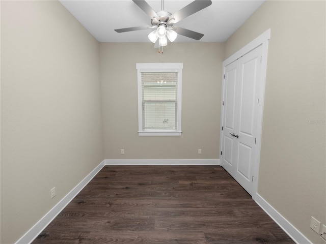 empty room featuring dark hardwood / wood-style flooring and ceiling fan