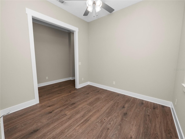 unfurnished bedroom with dark hardwood / wood-style flooring and ceiling fan