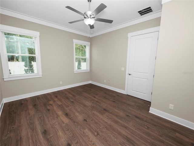 unfurnished room featuring dark hardwood / wood-style floors, plenty of natural light, and crown molding