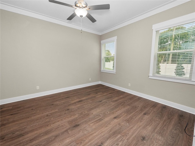 unfurnished room with dark wood-type flooring, a wealth of natural light, and ornamental molding