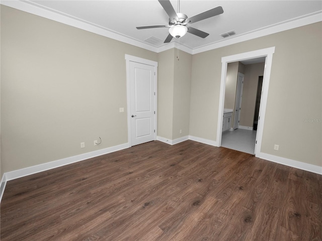 spare room with crown molding, ceiling fan, and dark wood-type flooring