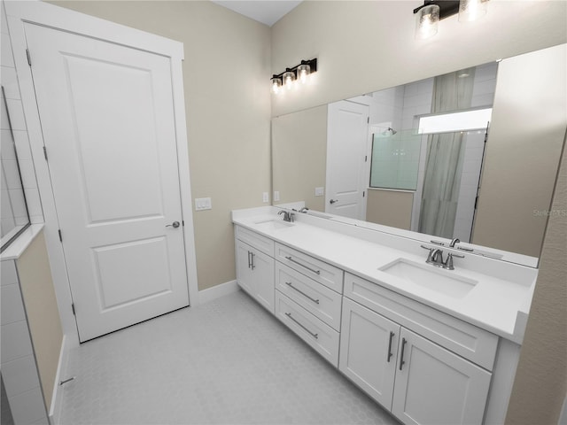 bathroom featuring tile patterned flooring, vanity, and tiled shower