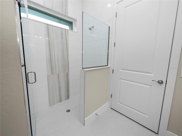 bathroom with tile patterned flooring and an enclosed shower