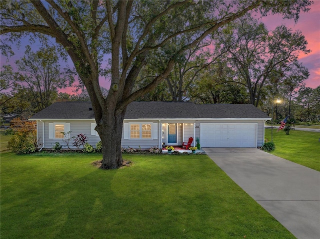 ranch-style house featuring a yard and a garage