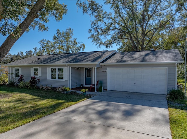 ranch-style house featuring a front yard and a garage