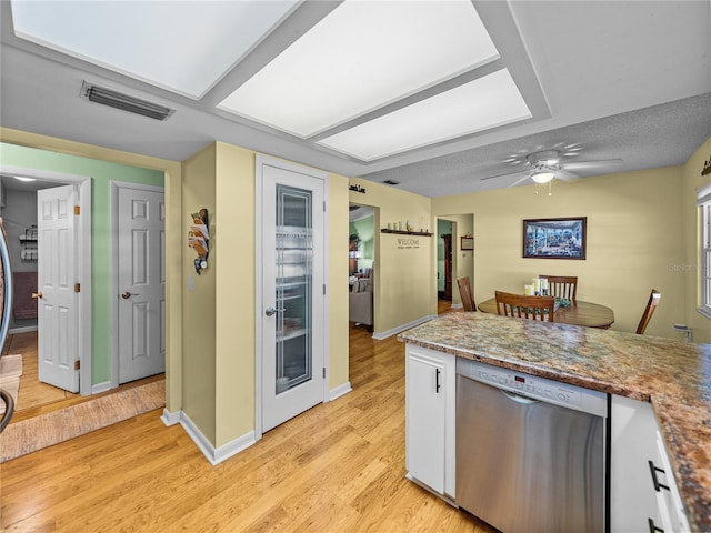 kitchen featuring dishwasher, light wood-type flooring, white cabinets, and ceiling fan