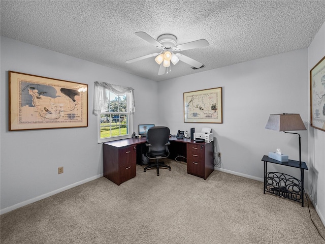 carpeted home office featuring ceiling fan and a textured ceiling