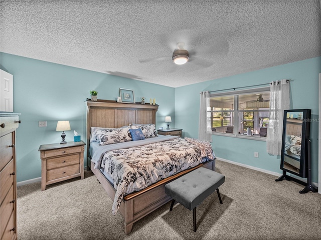 carpeted bedroom featuring ceiling fan and a textured ceiling