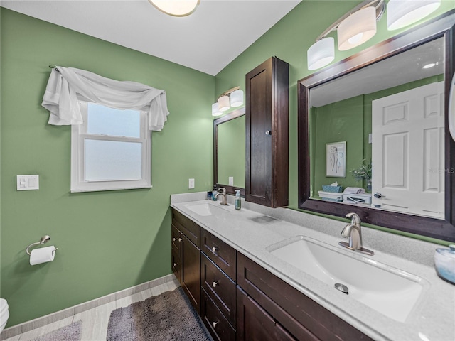 bathroom featuring vanity and toilet