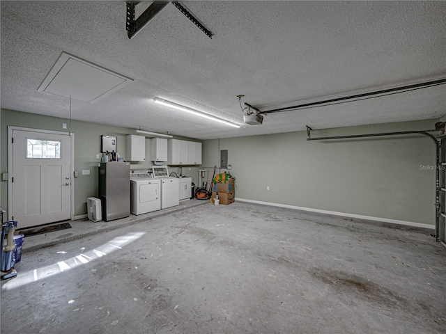 garage with washing machine and clothes dryer and a garage door opener