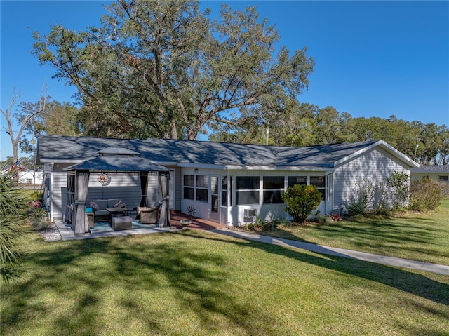 rear view of house featuring a gazebo, a patio area, a yard, and outdoor lounge area