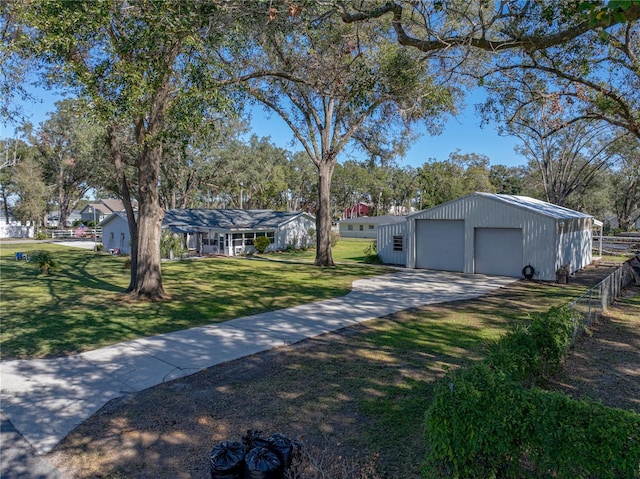 ranch-style house featuring an outbuilding, a front lawn, and a garage