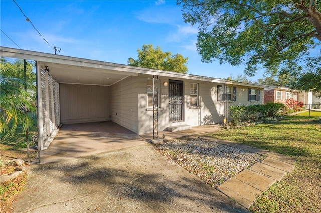 ranch-style house featuring a front yard and a carport