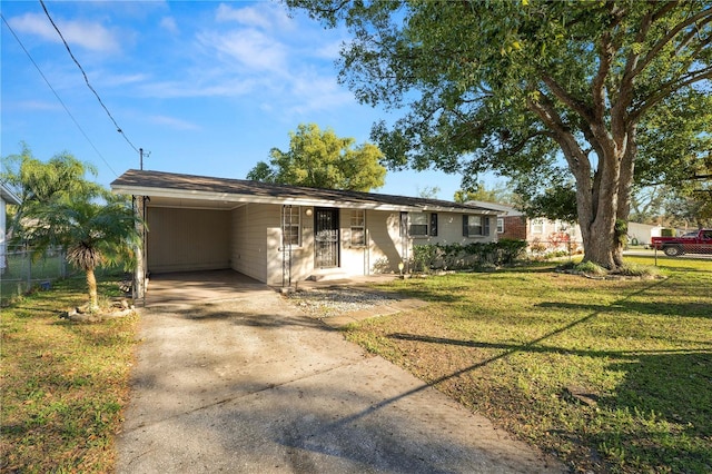 ranch-style house featuring a carport and a front lawn