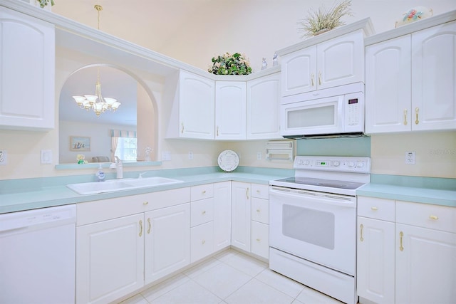 kitchen with white cabinets, white appliances, a notable chandelier, and sink