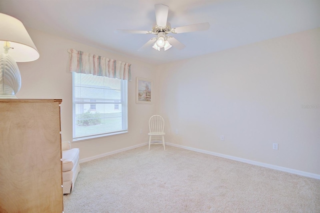 carpeted spare room featuring ceiling fan