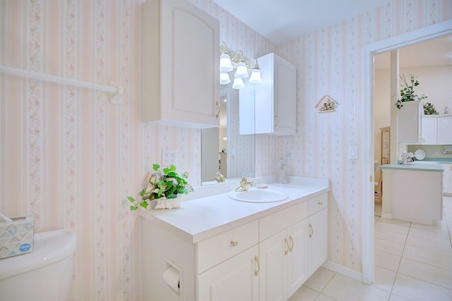 bathroom featuring tile patterned flooring, vanity, and toilet