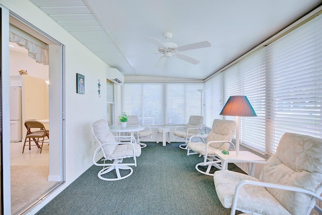 sunroom / solarium featuring a wall mounted AC and ceiling fan