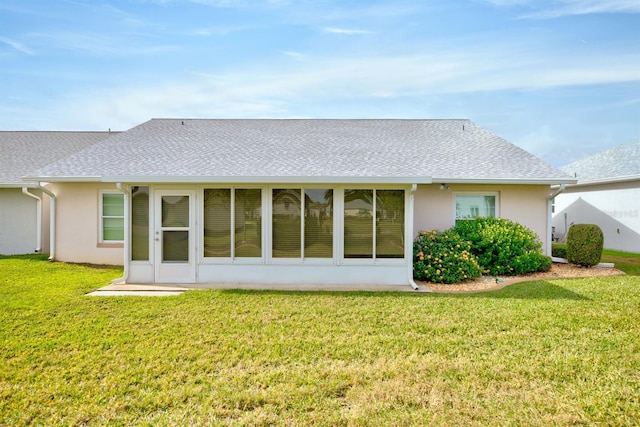 rear view of house featuring a lawn