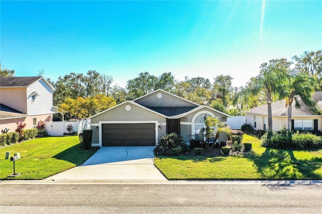 view of front of house featuring a garage and a front lawn