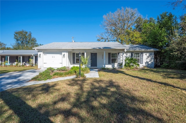 single story home with covered porch, a garage, and a front yard