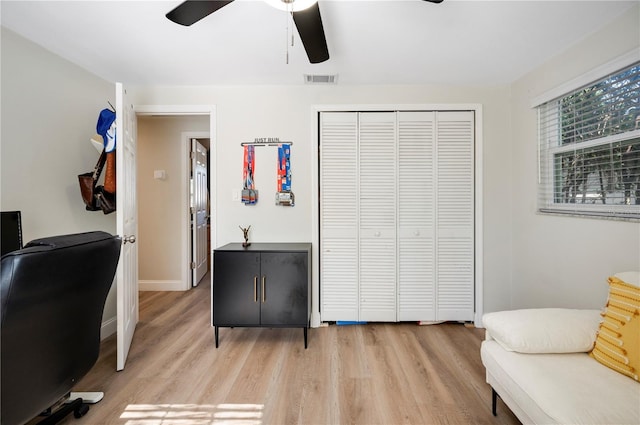 office space featuring ceiling fan and light hardwood / wood-style floors