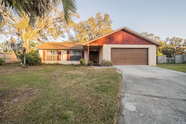 ranch-style home with a garage and a front lawn