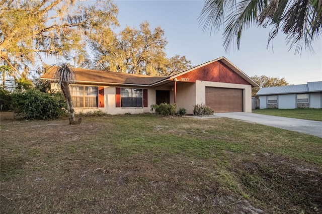 ranch-style home featuring a garage and a front lawn