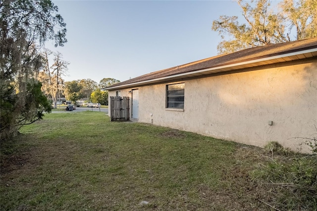 view of property exterior with a yard