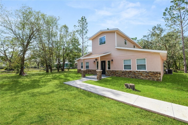 view of front facade with central AC unit and a front yard