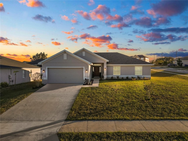 single story home with a garage and a yard