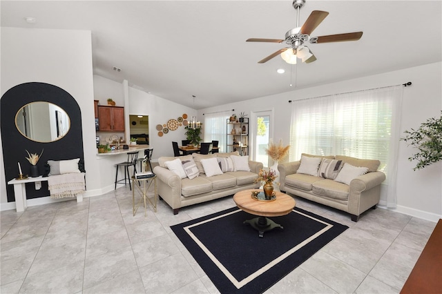 living room featuring vaulted ceiling and ceiling fan