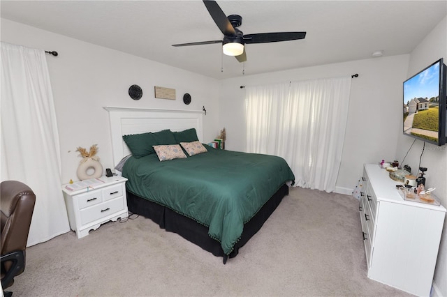 bedroom with ceiling fan and light colored carpet