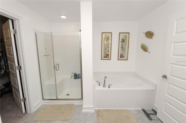 bathroom with tile patterned floors and independent shower and bath