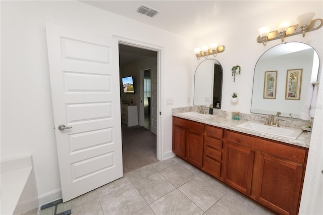 bathroom featuring tile patterned flooring and vanity