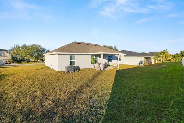 back of house featuring a yard, a patio, and central air condition unit