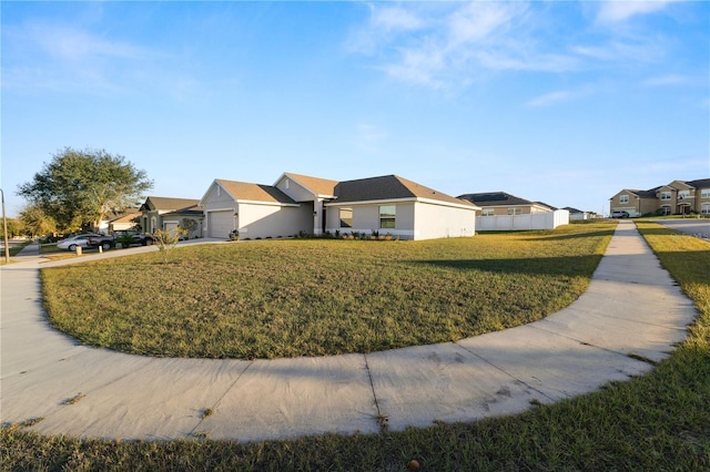 view of side of property with a lawn and a garage