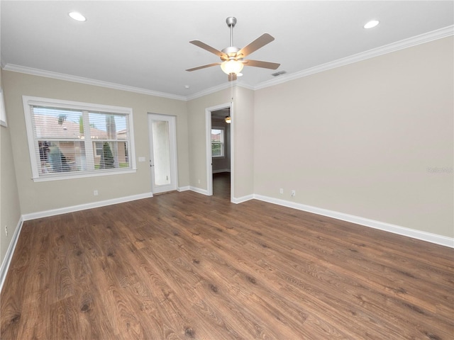 empty room with ceiling fan, dark wood-type flooring, and ornamental molding