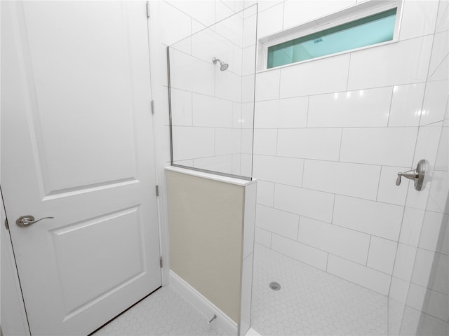 bathroom featuring tile patterned floors and tiled shower