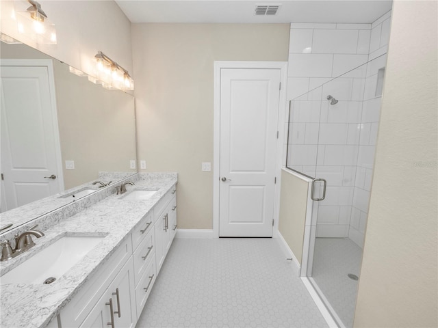 bathroom featuring a shower with shower door and vanity