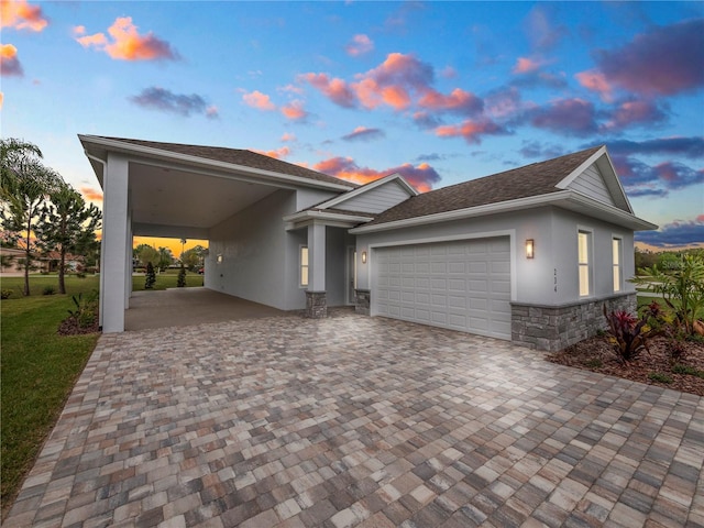 view of front of home with a carport and a garage