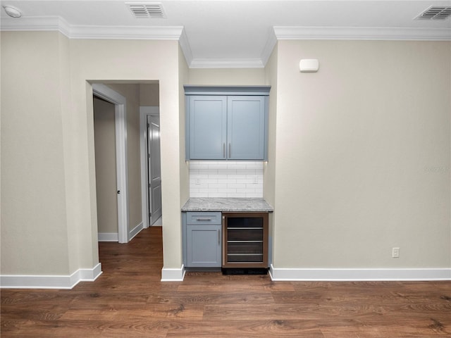 bar featuring dark hardwood / wood-style floors, ornamental molding, beverage cooler, and tasteful backsplash