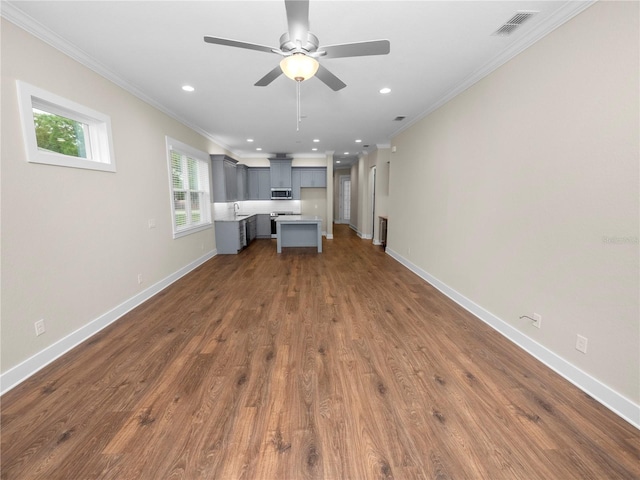 unfurnished living room featuring ceiling fan, sink, dark hardwood / wood-style flooring, and crown molding