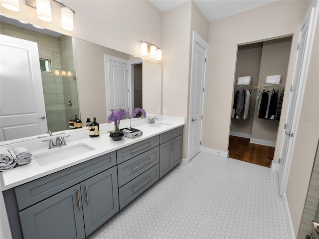 bathroom featuring tile patterned floors, an enclosed shower, and vanity